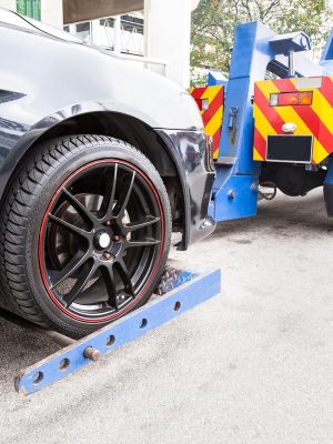 tow-truck-towing-a-broken-down-car-on-the-street-P46CHJA.jpg